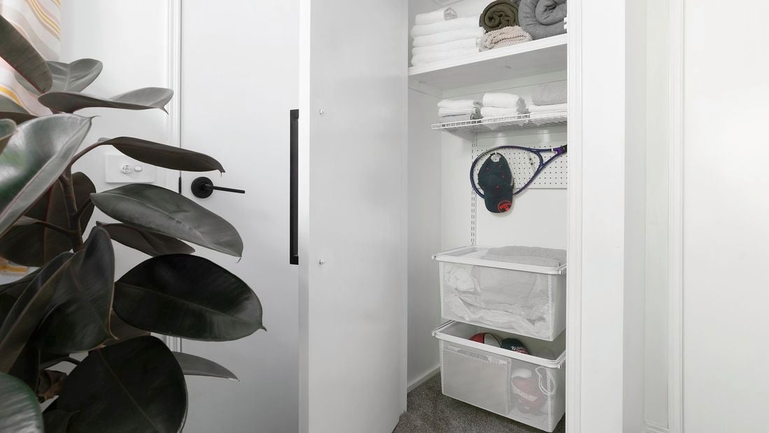 A well organised linen closet with a stylish Bunnings cap