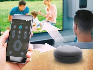 Hand holding a smartphone remote app controlling a TV displaying a family scene, with arrows indicating wireless connection to a smart speaker on a table.