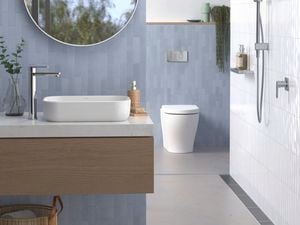 Blue tiled bathroom with silver tapware.