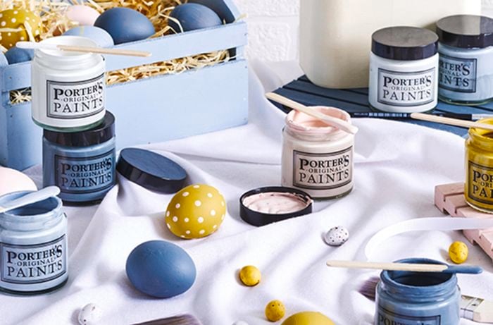 Painted eggs and paint tubs on a silk sheet