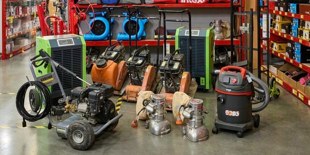 Bunnings Hire Shop equipment display with pressure washers, floor sanders and other tools available for hire.