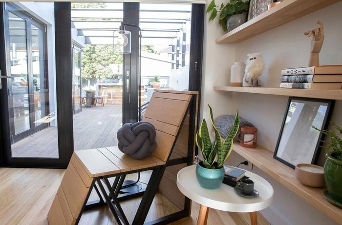 Chair and floating shelves by a door