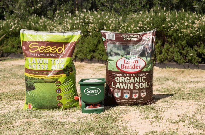 lawn care products, including Seasol Lawn Top Dress Mix, Scotts Lawn Builder Organic Lawn Soil, and a Scotts fertilizer spreader, required to maintain a healthy lawn. 
