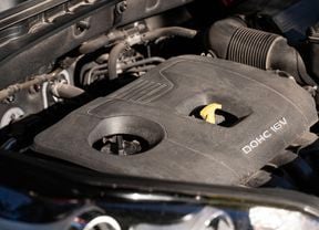 a close-up of a car engine with the oil dipstick securely placed back in position.