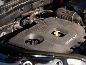 a close-up of a car engine with the oil dipstick securely placed back in position.