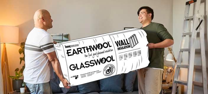 two men bringing in an insulation roll