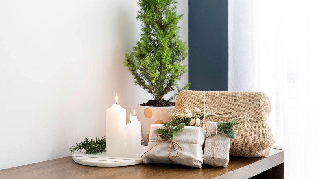Table with presents and small pine tree on it.