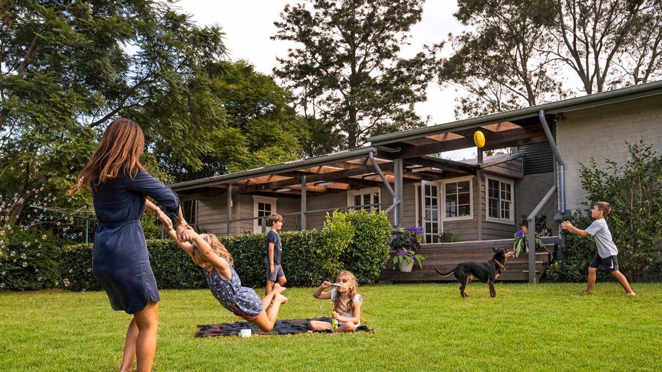Group of people playing on a backyard lawn
