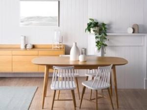 Simple, clean dining room interior with wooden table and white chairs