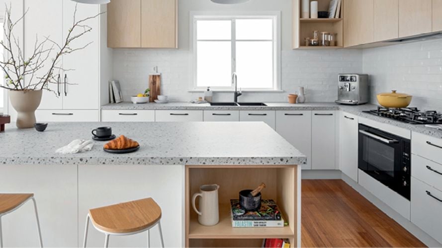 white kitchen with stone bench tops and timber cupboards