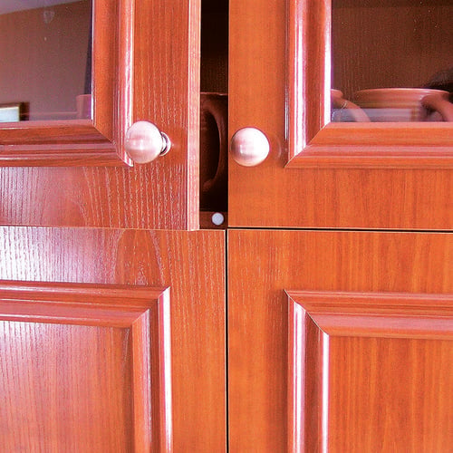Cabinet door with door frame protection