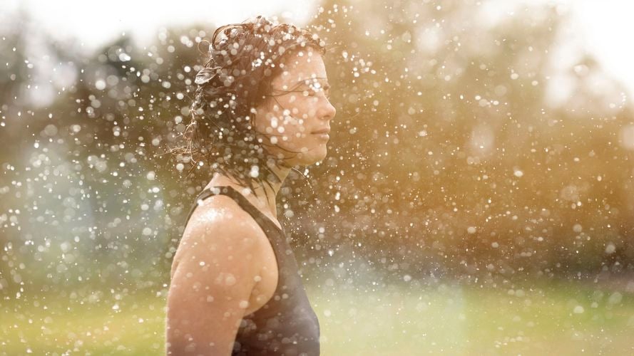 Woman outside surrounded by drop of water