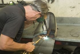 Person welding while wearing mask