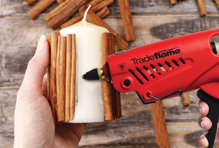 A Tradeflame gun used to secure cinnamon sticks to a scented candle
