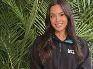 Bunnings Trade Landscape Specialist Vic stands in a black work shirt behind a large plant.