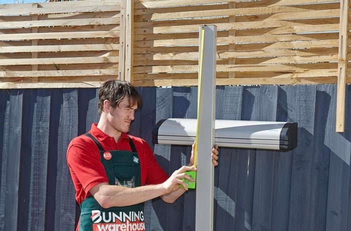 Measuring the length from the top of the post down to the middle of the unit.