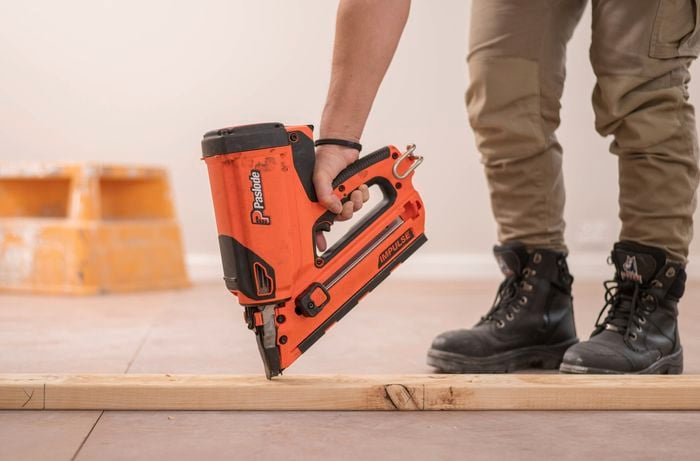 Secure the bottom plate to the floor using a nail gun 