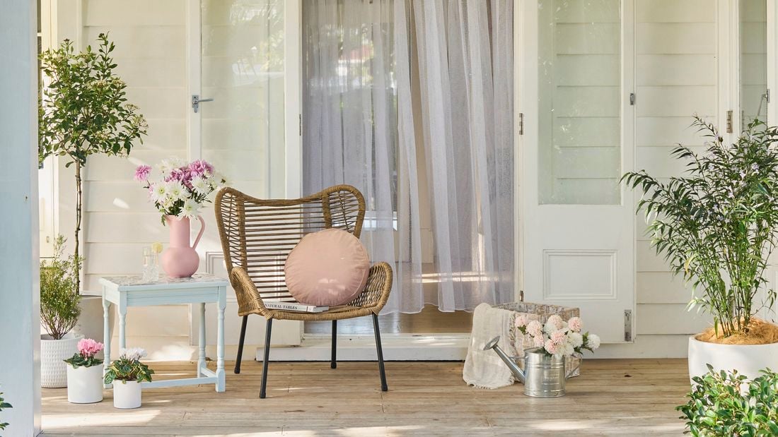 An outdoor furniture setting in a spring garden
