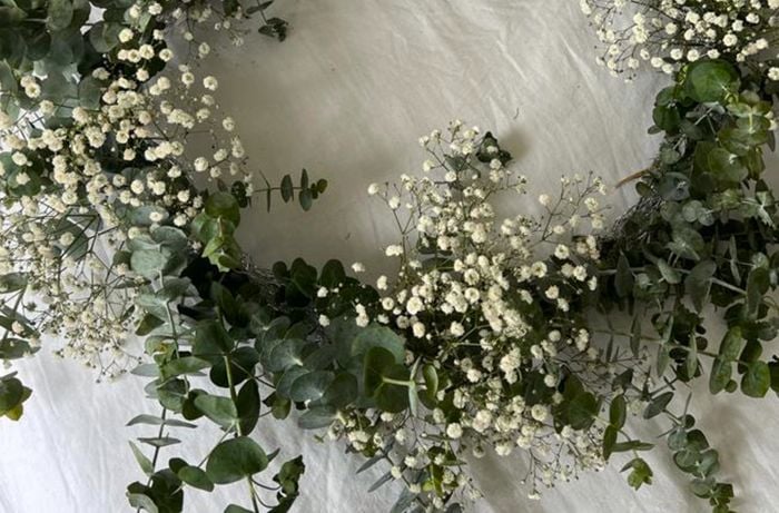 Leaves, flowers and foliage added to chicken wire wreath and a festive pattern