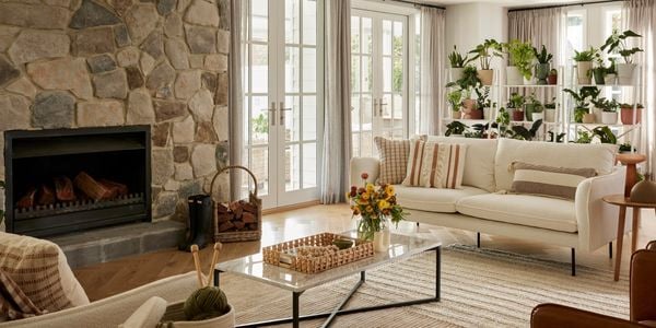 Living room setting with small coffee table and a couch placed on a rug.