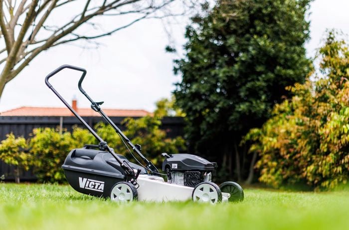 Lawn mower machine in garden.