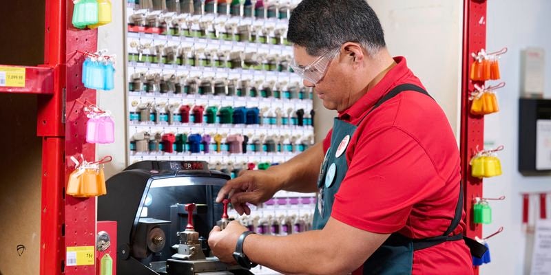 Team member using the key cutting machine 