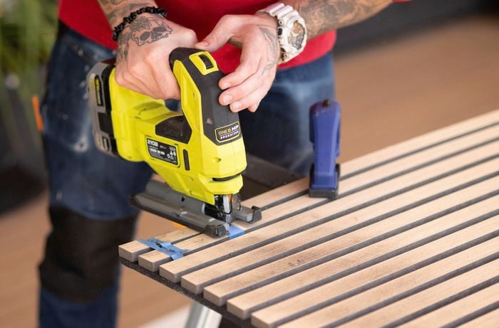Cutting a cutout on a timber panel with Jigsaw.