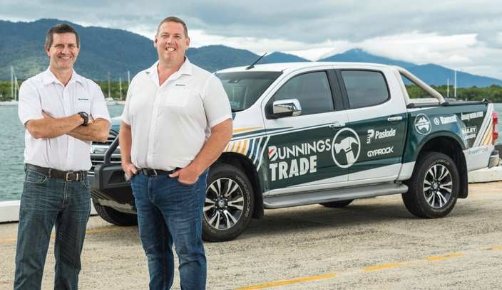 Two men smiling, standing in front of a Bunnings Trade Ute.