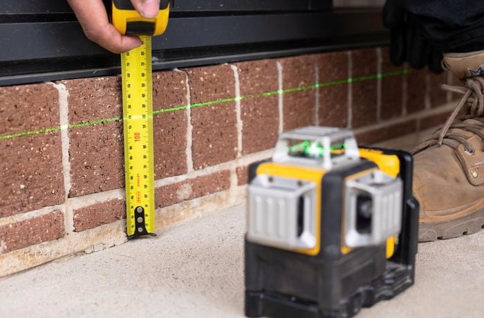 Measuring stump height using line laser and measuring tape.