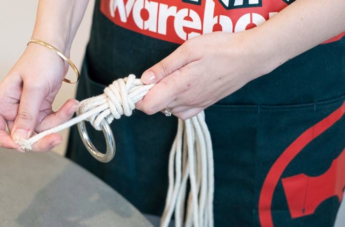 Typing a loop knot near a brass ring