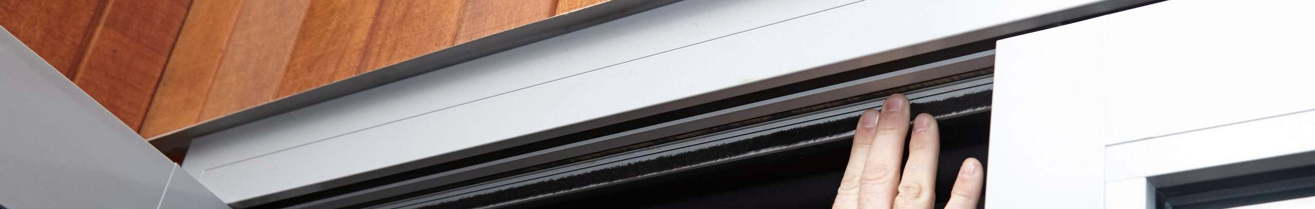 Close up shot of a roof vent on a tin roof with a deep blue sky in the background