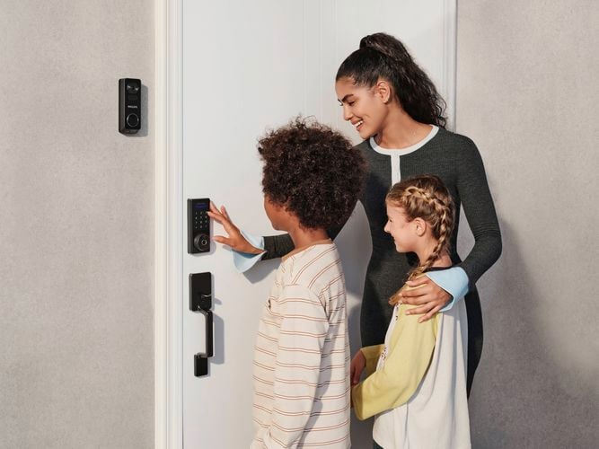 Front door equipped with a Philips Smart Lock fingerprint scanner and Philips Video Doorbell being used.