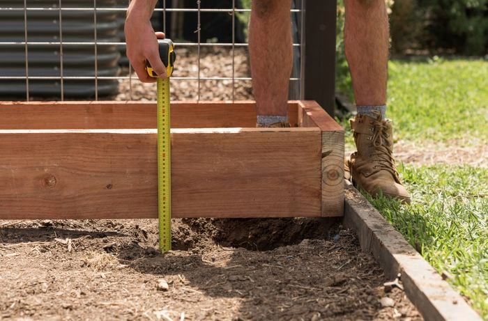  Measure raised garden bed height to cut upright posts