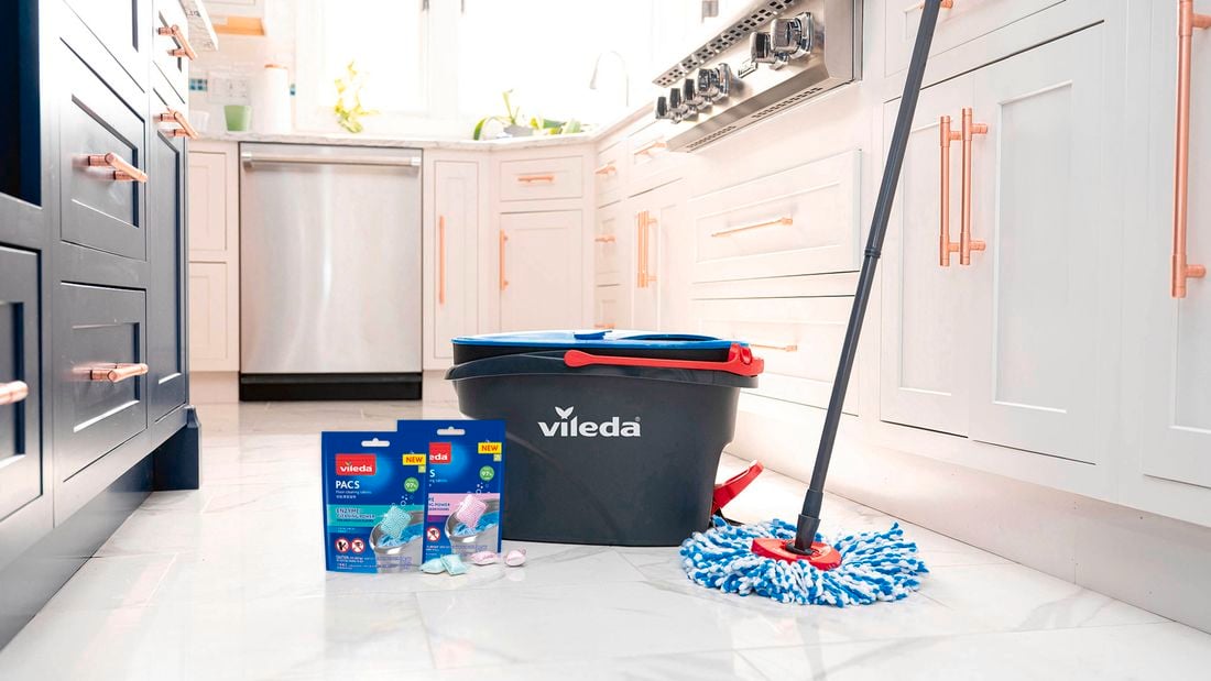 Vileda mop and bucket on a kitchen floor beside two PACS packets