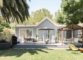 Backyard with a decking, outdoor furniture and gazebo.