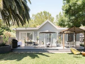 Backyard with a decking, outdoor furniture and gazebo.