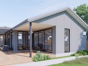 back garden with grey house and timber decking, plants and outdoor setting.