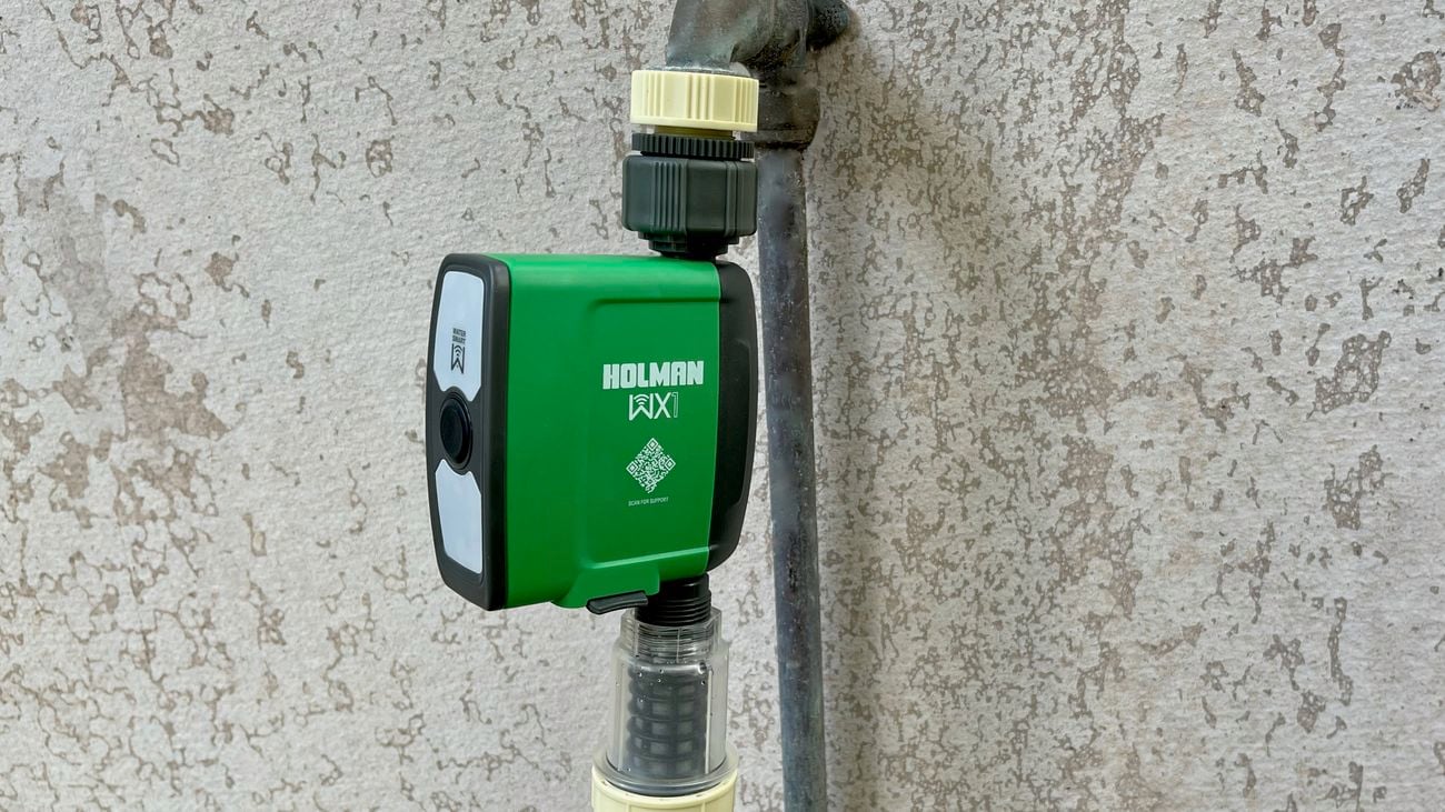 Green, digital water timer attached to a hose 