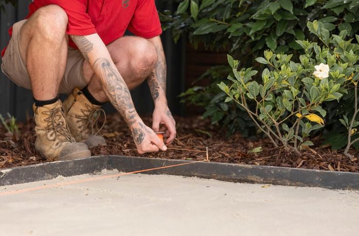 Set up a string line to ensure it aligns with the edge of the first paver 