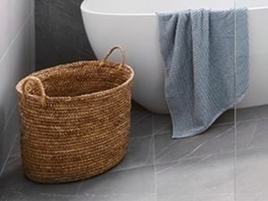 Woven basket on bathroom tiles