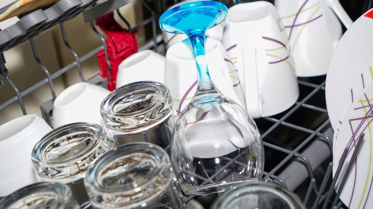 Freshly washed glasses and plates from the dishwasher ready to be cleared out