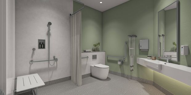 Contemporary accessible bathroom with a roll-in shower, folding shower seat, grab rails, accessible toilet, wall-mounted sink and mirror. The design features green and white walls, terrazzo-style flooring and ample open space to support accessibility and ease of movement.