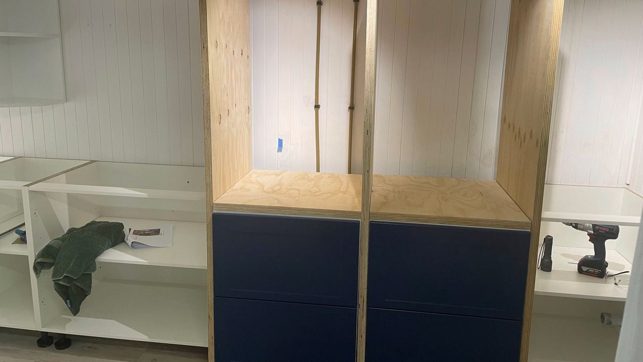 A room with wooden shelves in it.