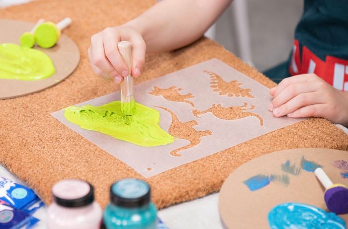 Paint the doormat using a stencil and sponge brush to paint shapes