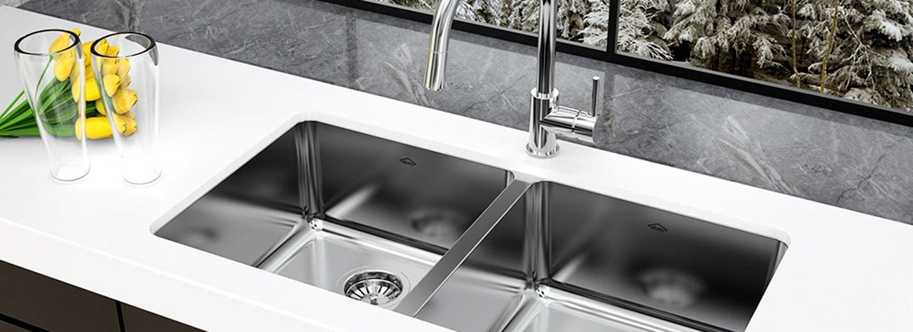 Kitchen benchtop with stainless steel sink and tapware