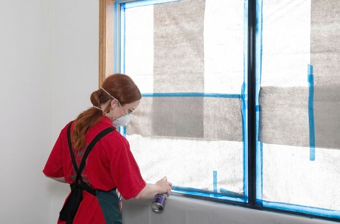 A window frame being spray painted