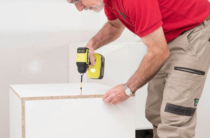 Fix the side panels to the cabinet frame