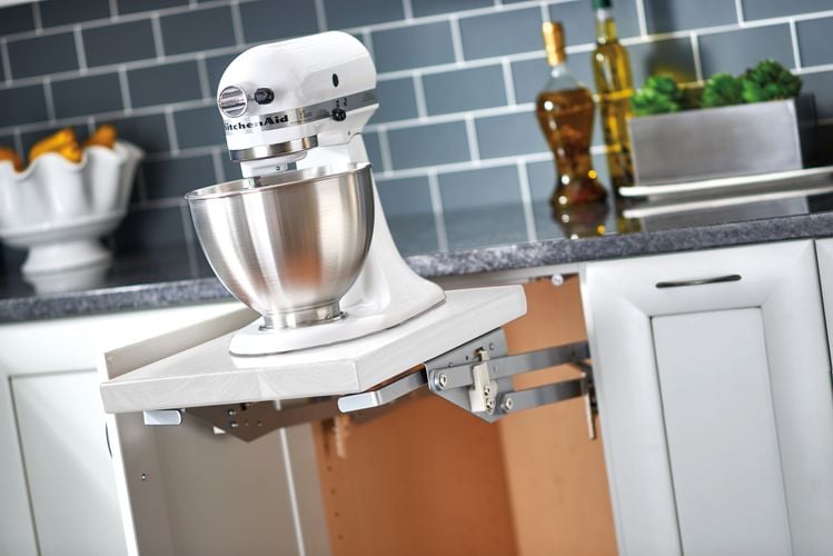 Open kitchen cupboard with pull out bench for cake mixer