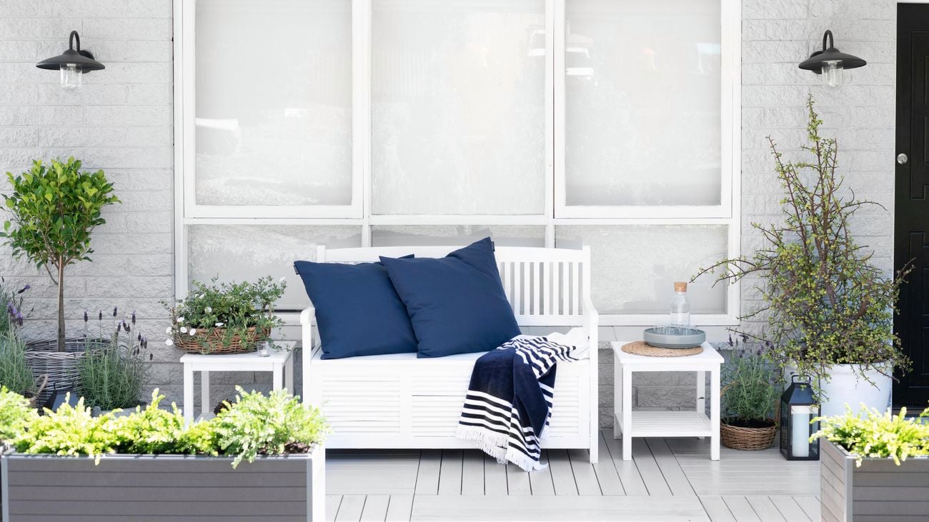 White paint on timber windows in an outdoor setting with outdoor furniture and cushions.