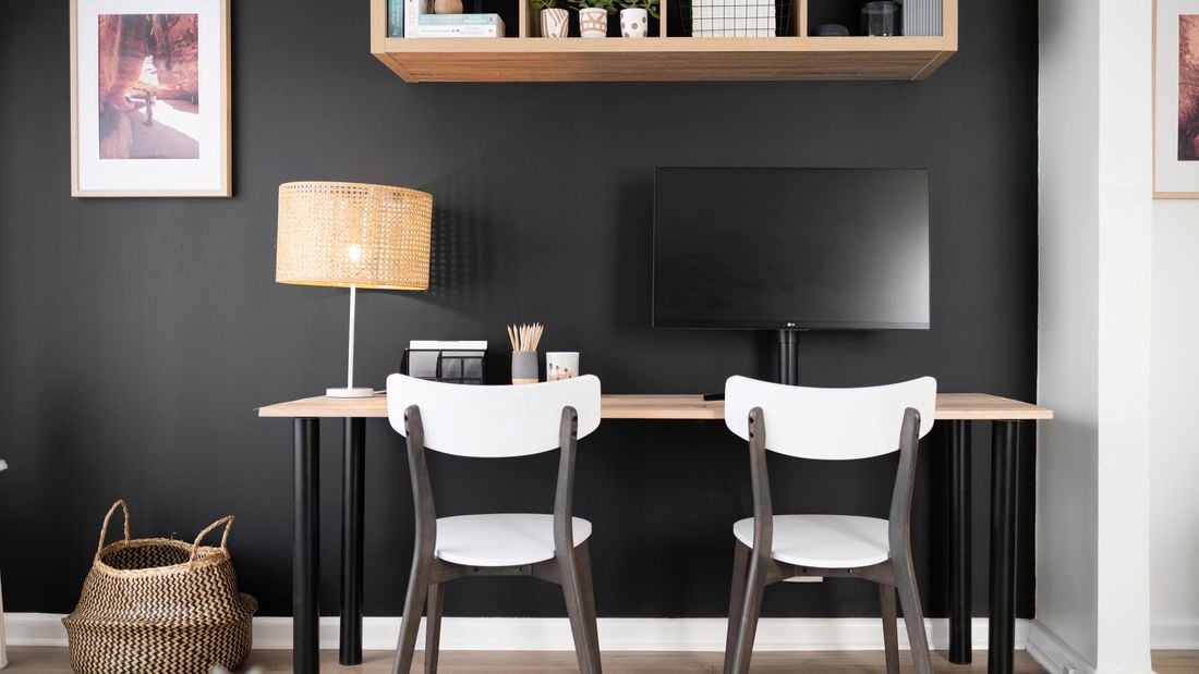 A study nook against a darkly painted wall